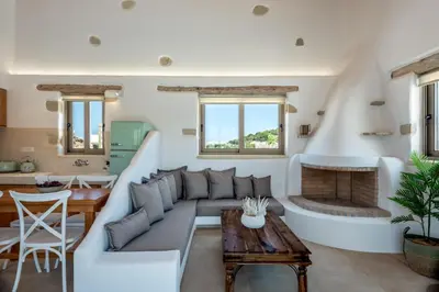 a living room with a couch and a fireplace at Villa Froudi in Kissamos