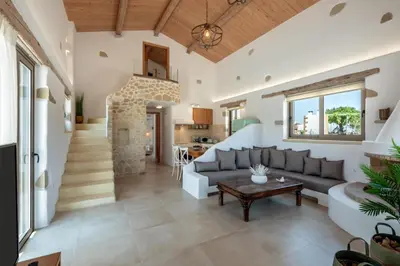 a living room with a couch and a table at Villa Froudi in Kissamos
