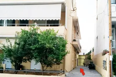 a tree in the middle of a building with a red arrow at Studio Victory Chania in Chania Town