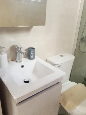 a bathroom with a white sink and a toilet at Studio Victory Chania in Chania Town