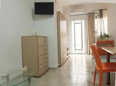 a living room with a dresser and a dining room at Studio Victory Chania in Chania Town