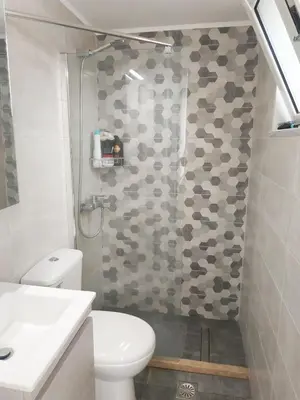a bathroom with a shower with a toilet and a sink at Studio Victory Chania in Chania Town