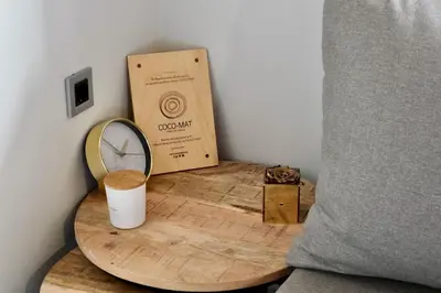 a wooden table with a clock and a box at Metropolitan Pearl Boutique Hotel in Chania Town