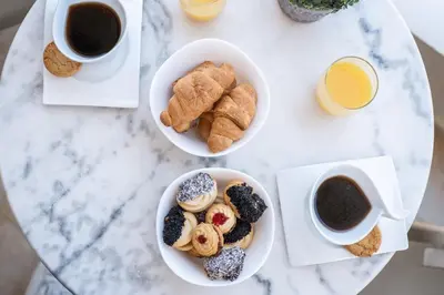 a table with two bowls of pastries and two cups of coffee at Ammoutsiani Cozy Apartment 1 by 8essentially in Chania Town