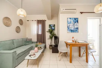 a living room with a couch and a table at Ammoutsiani Cozy Apartment 1 by 8essentially in Chania Town