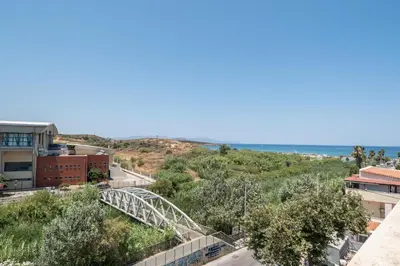 a bridge over a road in a city with the ocean at Ammoutsiani Cozy Apartment 1 by 8essentially in Chania Town