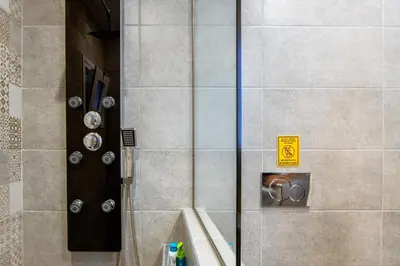 a shower with a glass door and a sink at Kares Dream House in Chania Town