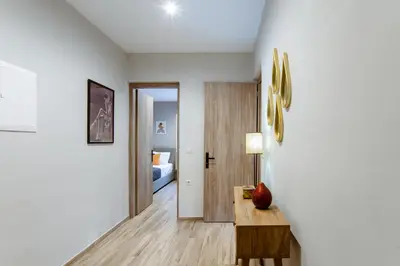 a living room with a table and a bedroom at Kares Dream House in Chania Town