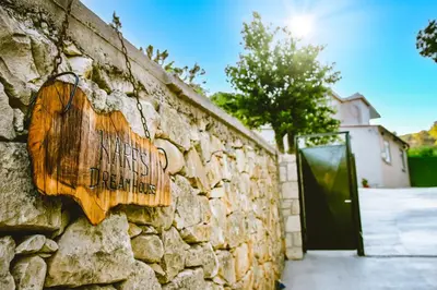 a stone wall with a sign that reads hidden doors at Kares Dream House in Chania Town