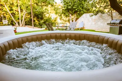 a hot tub filled with water in a backyard at Kares Dream House in Chania Town