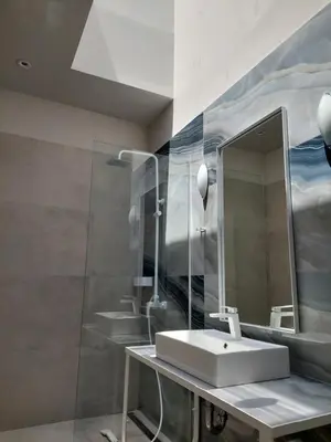 a bathroom with a sink and a mirror at TheJoy Residence Apartments in Chania Town