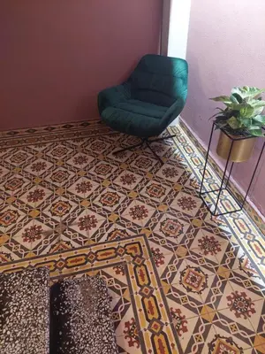 a room with a chair and a tile floor at TheJoy Residence Apartments in Chania Town