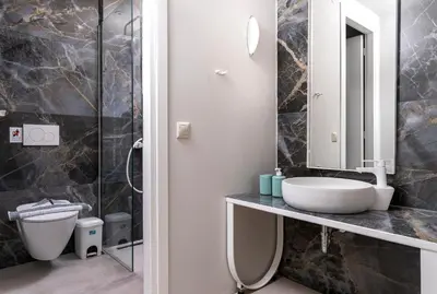 a bathroom with a sink and a shower at TheJoy Residence Apartments in Chania Town