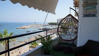 a balcony with a view of a beach and the ocean at KM Beach View apartment in Chania Town