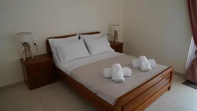a bedroom with a bed with two towels on it at KM Beach View apartment in Chania Town