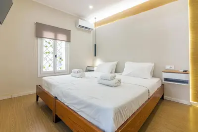 a bedroom with a large white bed with towels on it at Stef&Art Old Town House in Chania Town