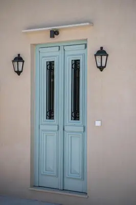 a blue door on the side of a building at Mythodea Luxury Suites in Chania Town