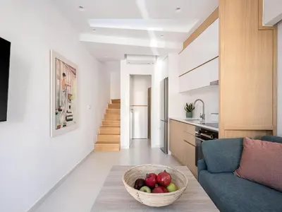 a living room with a bowl of fruit on the floor at Mythodea Luxury Suites in Chania Town