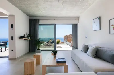 a living room with a couch and a table at Krystallon Villas in Palaiochóra
