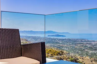 a table and chairs with a view of a city at Villa Lia Chania with private ecologic pool and amazing view! in Chania Town