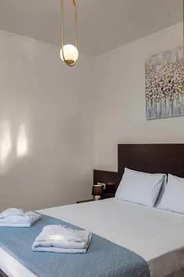 a bedroom with a bed with two towels on it at Villa Lia Chania with private ecologic pool and amazing view! in Chania Town