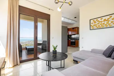 a living room with a couch and a table at Villa Lia Chania with private ecologic pool and amazing view! in Chania Town