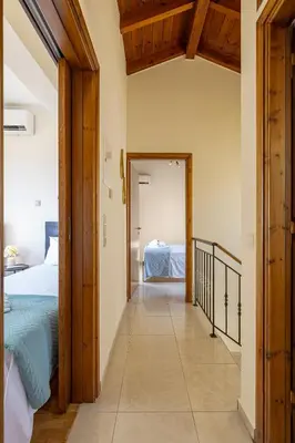 a hallway leading to a bedroom with a bed at Villa Lia Chania with private ecologic pool and amazing view! in Chania Town