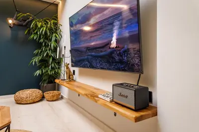 a living room with a tv on a wall at Mimosa Urban Habitation in Chania Town