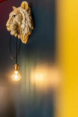 a lamp with a lion head on a wall at Mimosa Urban Habitation in Chania Town