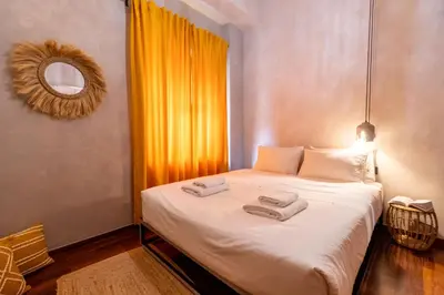 a bedroom with a bed with two towels on it at Mimosa Urban Habitation in Chania Town
