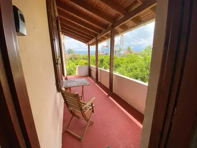 a balcony with two chairs and a table on it at Dusk Apartments with Stunning Mountain View in Chania Town