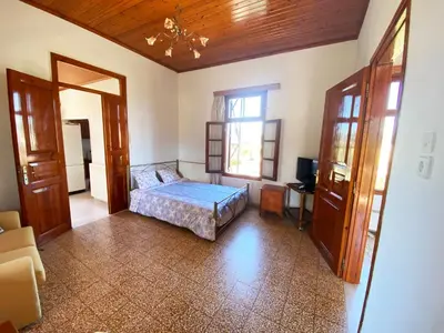 a bedroom with a bed and a window at Dusk Apartments with Stunning Mountain View in Chania Town