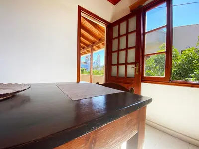 a room with a bed and a window and a table at Dusk Apartments with Stunning Mountain View in Chania Town