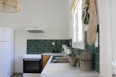 a kitchen with a sink and a stove at Cassandra's Haven in Kissamos