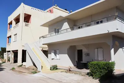 a white house with a staircase in front of it at Cassandra's Haven in Kissamos