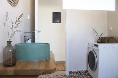 a laundry room with a washing machine and a washer at Cassandra's Haven in Kissamos
