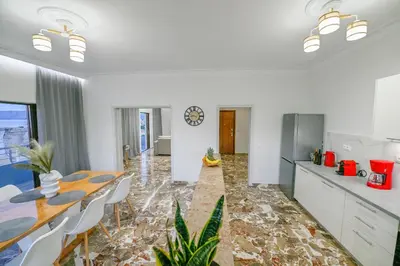 a kitchen and dining room with a table and chairs at Blue Horizon Kisamos Deluxe Apartment in Kissamos