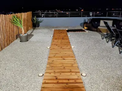 a wooden walkway on the roof of a building at Blue Horizon Kisamos Deluxe Apartment in Kissamos
