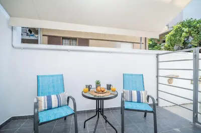a balcony with a table and two chairs at MYRTIA APARTMENT few steps from the sea in Chania Town