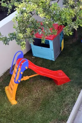 a childs play set on the grass with a toy microwave at VILLA BLUE VEDERE in Gerani Chanion