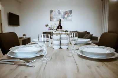 a table with a bottle of wine and glasses on it at OLIVE TREE in Galatás