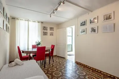 a dining room with a table and red chairs at Casa Lion in Chania Town
