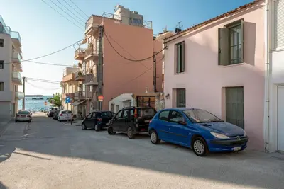 a blue car parked on a street next to buildings at Casa Lion in Chania Town