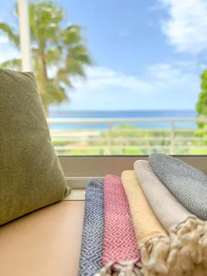 a group of ties sitting on a table in front of a window at Vista Mare in Palaiochóra
