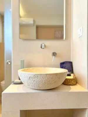 a bathroom with a bowl sink on a counter at Vista Mare in Palaiochóra