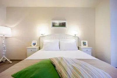a bedroom with a white bed with two night stands at Casa Del Porto in Chania Town