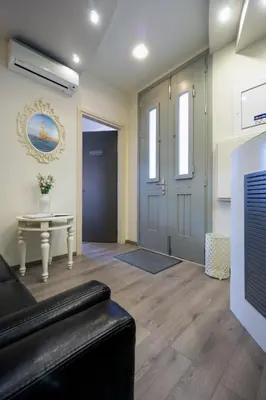 a living room with a couch and a table and a door at Casa Del Porto in Chania Town