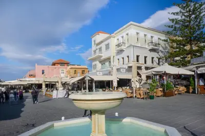 a fountain in the middle of a town square with buildings at Casa Del Porto in Chania Town
