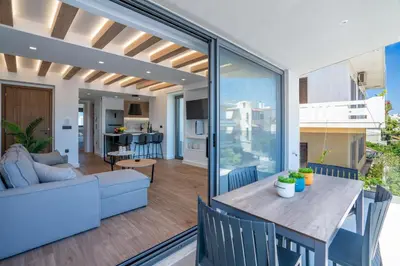 a living room and dining room with a table and chairs at Almy Luxury Apartments in Chania Town