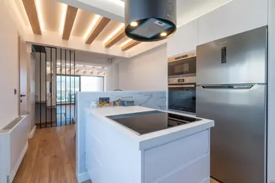 a kitchen with a sink and a refrigerator at Almy Luxury Apartments in Chania Town